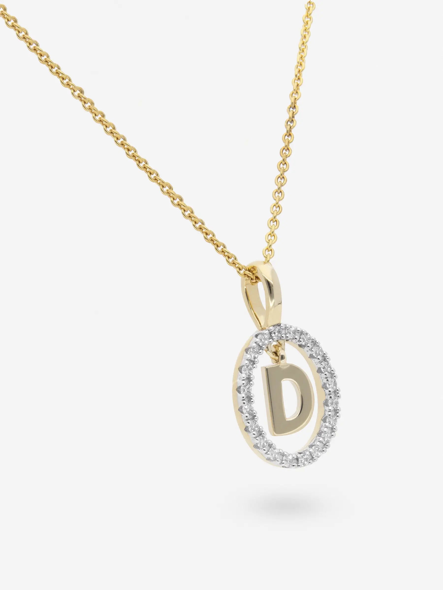Collar realizado en plata chapada en oro amarillo con la inicial D dentro de un circulo de topacios blancos